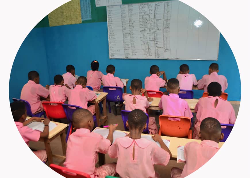 Primary classroom with students in uniforms studying
